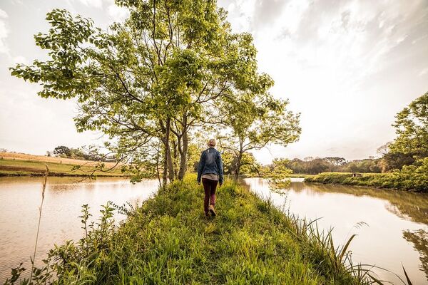 Person walking along a scenic path near water
